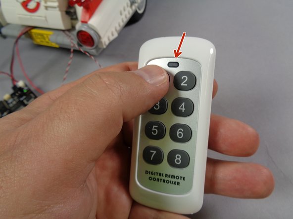 Finally, test the remote control by pressing any button on the remote transmitter, as shown in the first photo.