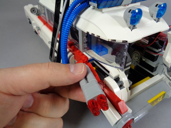 As shown in the first and second photos, re-attach the left tail light assembly and make sure the two LED Light wires pass toward the outside as shown by the green circle in the second photo.