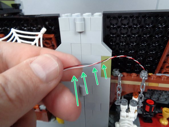 Un-twisting the section of wire that passes through the chimney will allow the chimney bricks to sit more firmly on top of the wire, and it also decreases the chances of the wire getting damaged.