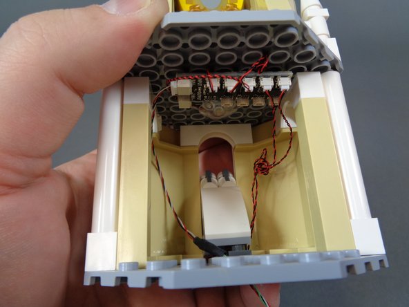 As shown in the first photo, coil up any excess wire in the lower room using a pencil or tweezers.