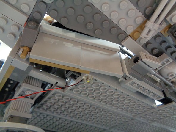 Before proceeding, make sure you can access the underside of your Falcon.  It is recommended that the model be positioned near the edge of a table, so you can access the underside of the model closest to the edge of the table.