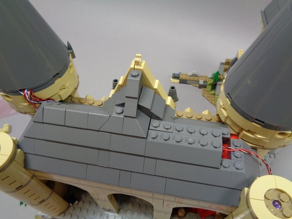 Continue re-attaching roof pieces as shown in the photos for this step.