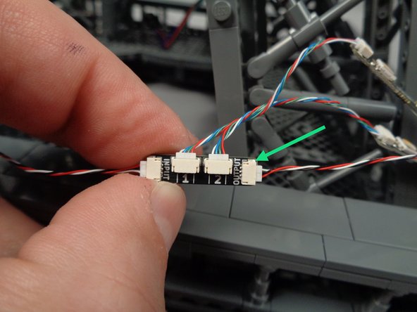 As shown by the green arrow in the photo for this step, connect another 3-wire control cable to the OUTPUT plug on the adapter board.