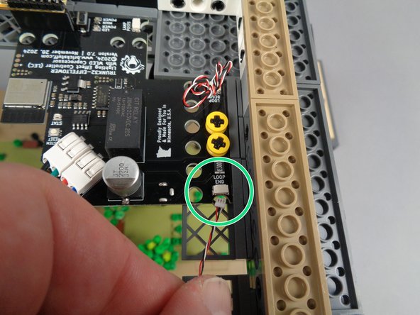 The first photo for this step shows the loose control cable connected to the OUTPUT plug on the fourth adapter board.