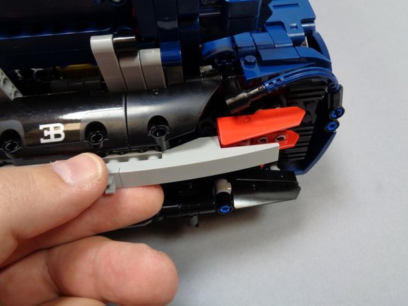 As shown in the three photos for this step, re-assemble the rear right turn signal and tail light mount.