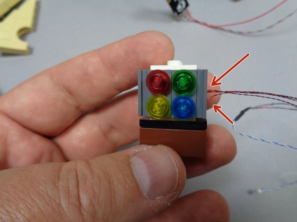 As shown by the red arrows in the third photo, make sure all four light wires extend out the right side of the window assembly.