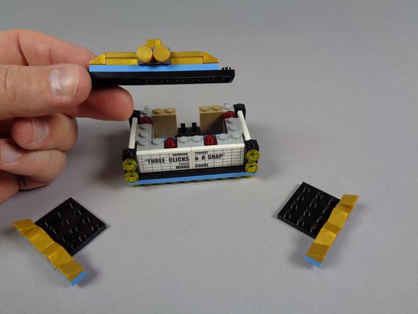 As shown in the photos for this step, begin disassembling your marquee bottom section.