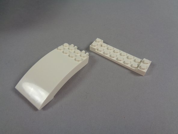 As shown in the first photo for this step, remove the large white plate from the white roof slope.