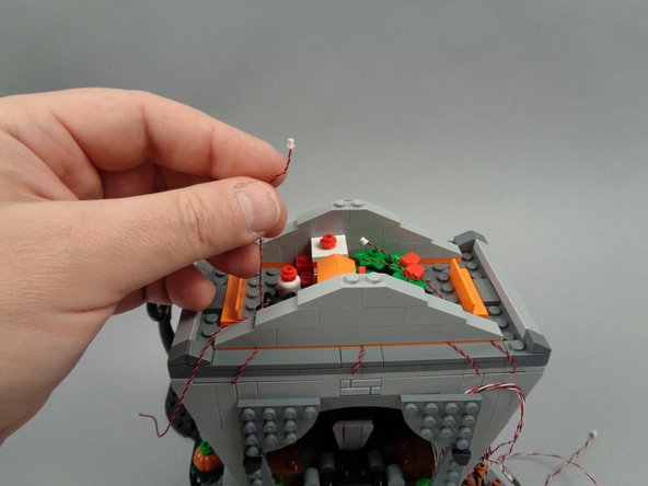 As shown in the first photo for this step, take the wire for the left torch.