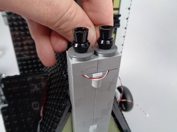 As shown by the green arrows in the first photo, make sure to leave a small amount of extra wire as &quot;slack&quot; outside the two halves of the chimney.  This ensures that the wire is not damaged by repeated opening and closing of the mansion sections.