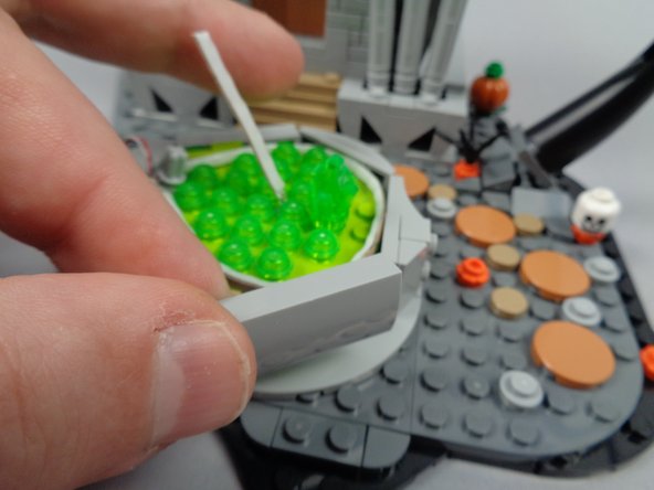 As shown in the first photo for this step, re-attach the side piece you removed earlier.