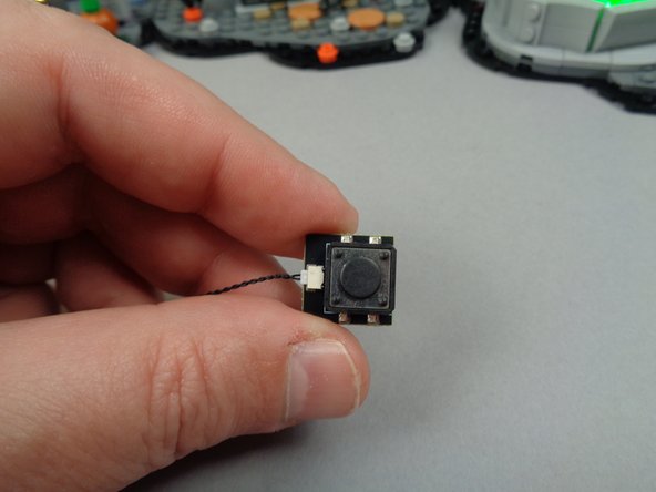 The first photo for this step shows the button and its connecting wire.