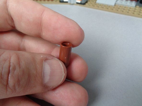 As shown in the first photo for this step, there should be a brown LEGO technic connector in the bag of LEGO parts in your BOX #1.