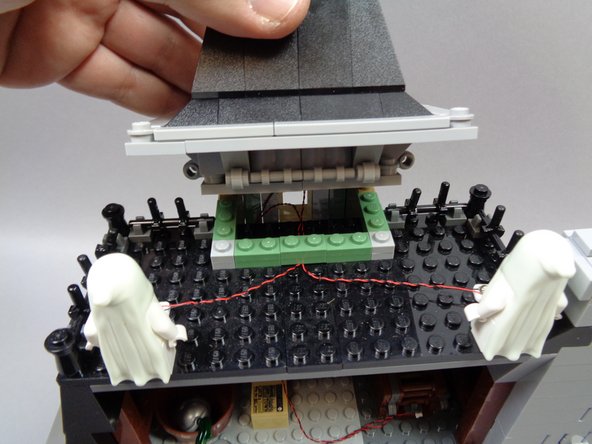As shown in the first and second photos, re-attach the cupola.  the ultraviolet light wires should now pass into the open area under the cupola.