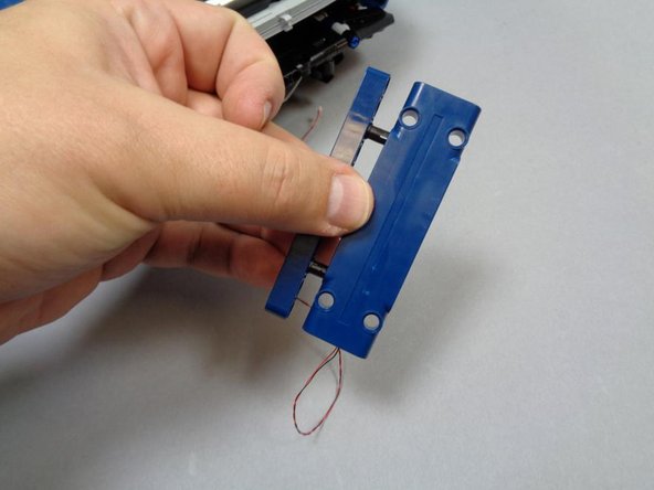 As shown in the three photos in this step, carefully remove the main spoiler panel from its fins and mount, and remove the blue Technic beam behind the spoiler panel.