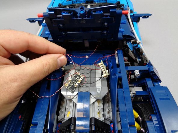 Taking the Pico LED cable you routed in the last step, connect it to one of the small connectors on the last BRANCH03 adapter board from Bag 1, and use the last 1.5&quot; black connecting cable to connect the interior LED to the last open plug on the master control board as shown by the red arrow in the third photo.