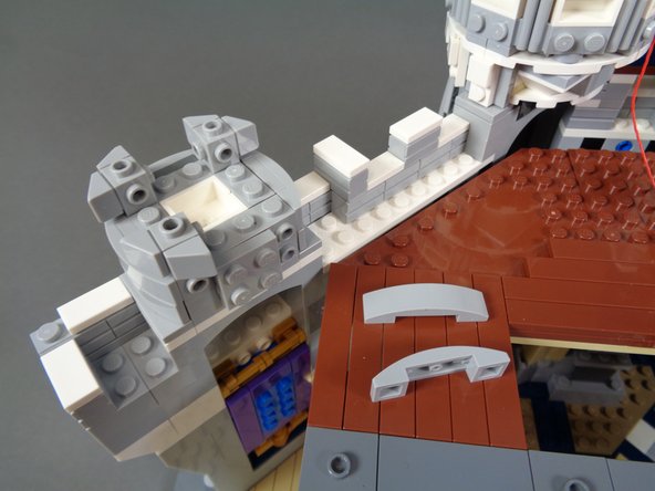 As shown in the photos for this step, remove the top and side pieces from the tower on the left in preparation for mounting the first light.