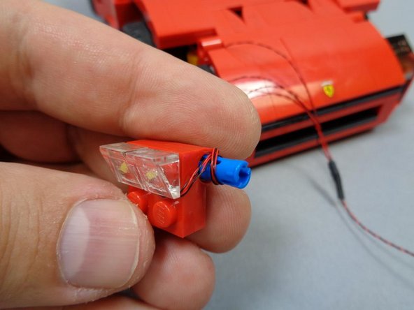 As shown in the first photo, wind the wires for the two main headlight LEDs around the blue Technic pin.