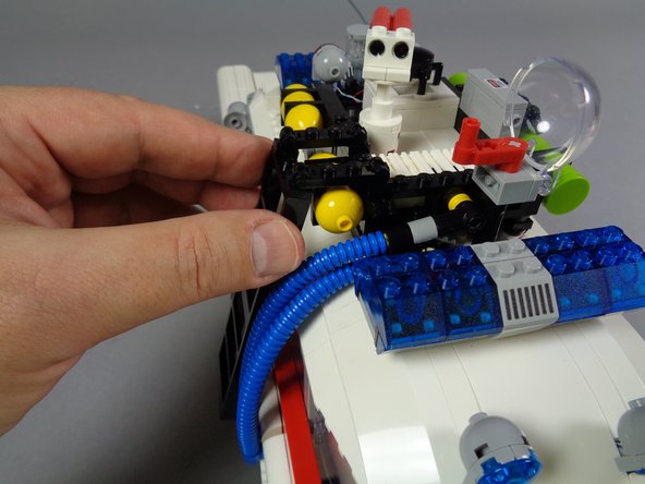 The three photos in this step show some of the parts to re-connect and re-attach.