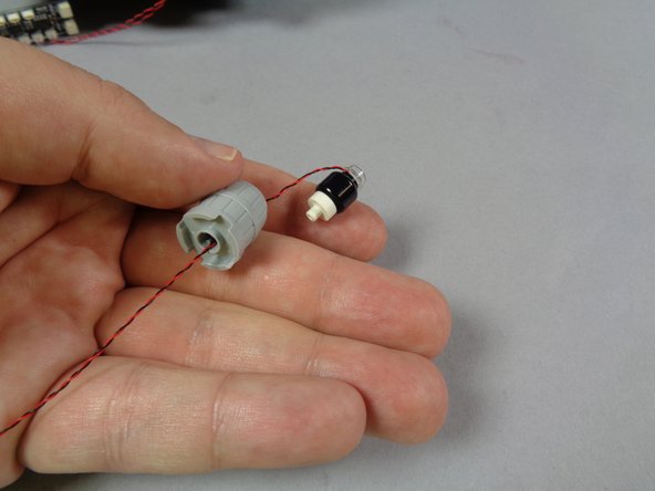 As shown in the second photo, pass the wire for the LED light through the inside of the barrel and out the hole in the back.