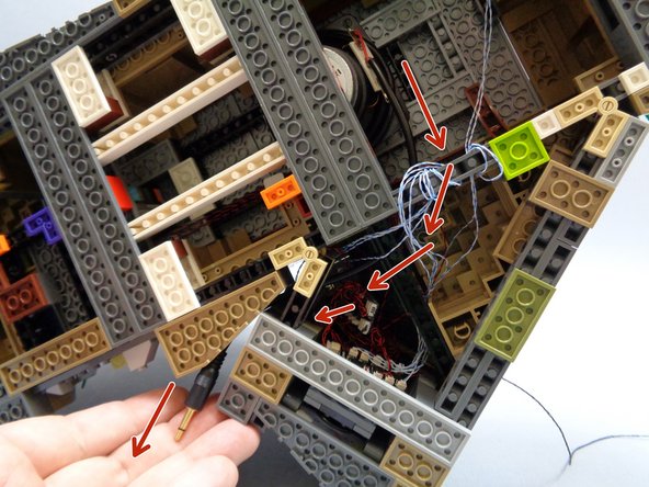 The plug for the speaker should hang out the back side of the castle.