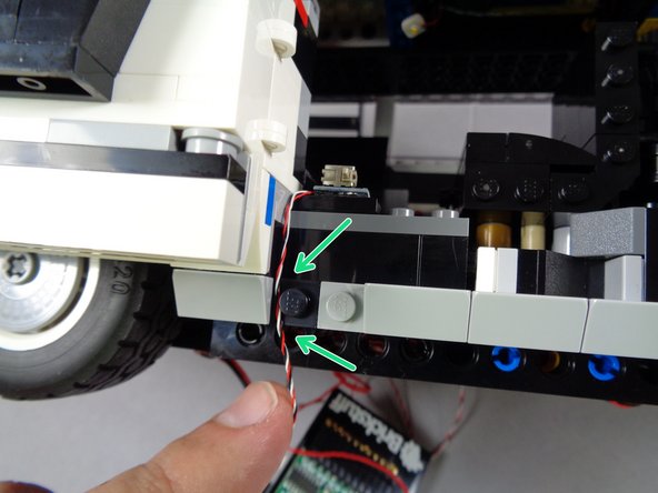 As shown by the green arrows in the second photo, run the switch wire down the side of the frame, making sure it passes between, not on top of, any studs.