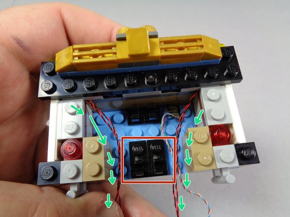 Before re-attaching the top marquee section, verify that all light wires pass out the back of the marquee without passing over the black plates with clips.
