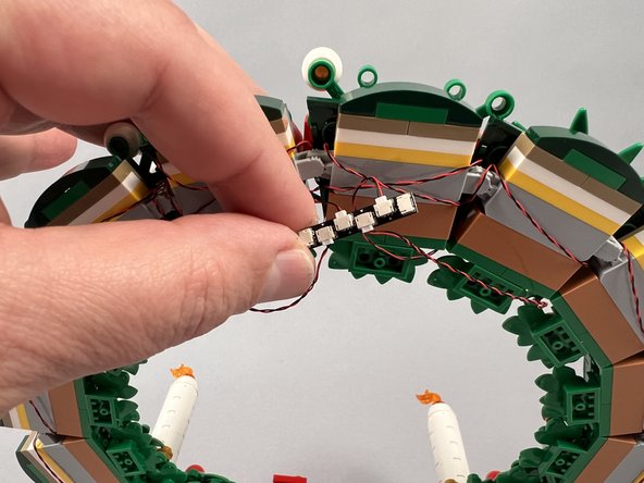 As shown in the first photo for this step, carefully connect the four light wires to the plugs on the BRANCH20 adapter board that is included with your Brickstuff kit.