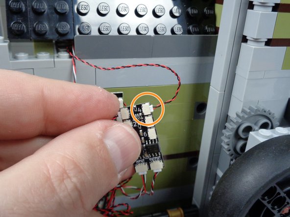 As shown by the orange circle in the third photo for this step, connect the skull jar LED light to plug #4 on the BRANCH06X adapter board.