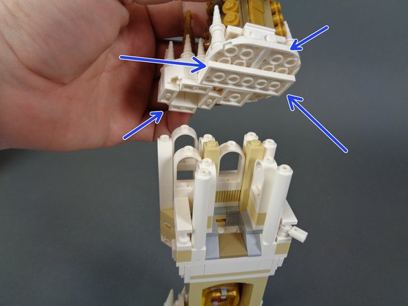 As shown in the second photo, carefully remove the top section of the upper tower so the flat white plates have separated (blue arrows).
