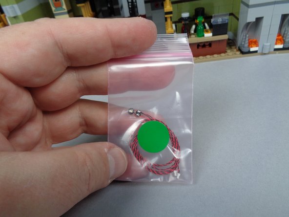Your BOX#2 contains a pink bag with a green sticker on it, as shown in the first photo for this step.  There are two green Pico LED lights in the bag.
