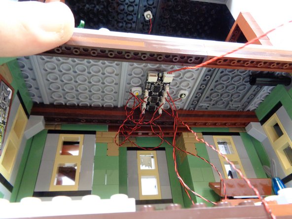 As shown by the blue arrow in the second photo, make sure the light wires pass around, not in front of, the center window.