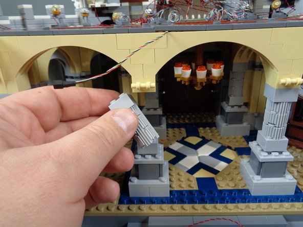 Inside the box labeled &quot;Interior Lights,&quot; remove the two pre-lit torches as shown in the first photo.