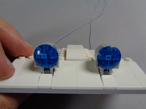 Follow the same steps you just completed to mount the blue LED light with longer wires in the first blue roof light, and mount a second blue LED light with longer wires inside the second roof light as shown in the photos for this step.