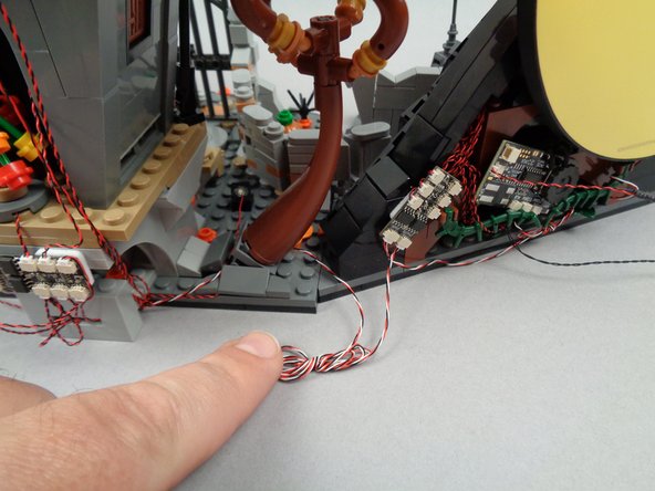 Optionally, as shown in the photos for this step, you may also choose to coil up excess wire for the control wires that run between sections of your LEGO set.  This will make for a cleaner setup, but just make sure the wires can be easily accessed if they need to be connected/disconnected in the future (for transport or movement of your LEGO set).