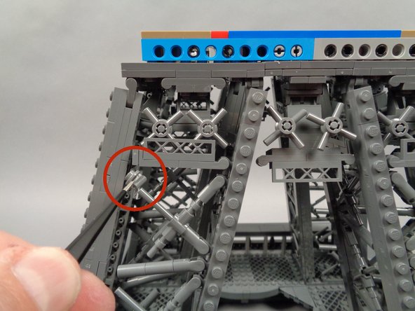 As shown by the red circle in the first photo for this step, remove the small piece that supports the horizontal walkway.  This needs to be removed to make room for the light strip.