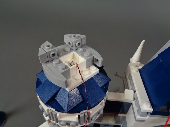 As shown in the photos for this step, remove the top and rear parts from the second tower so you can mount the second LED light.