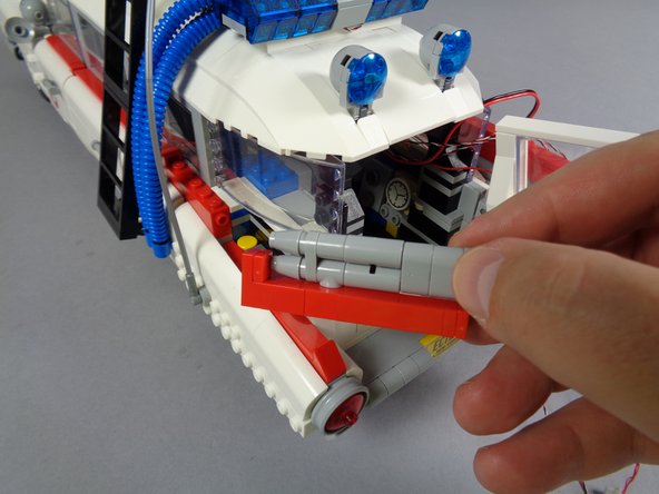 As shown in the photos for this step, disassemble and remove the left top tail light section.