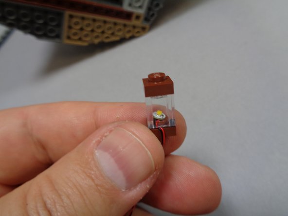 Use your fingernail to bend the wire down the side of the stud.  This will make it easier to attach the clear piece next.