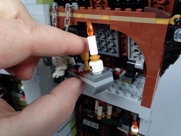 Next you will install two more pre-lit Brickstuff candles, this time in the attic above the front door.