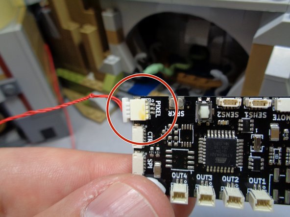 As shown in the second photo, you should have one red 3-wire connecting cable extending out the back of the castle.