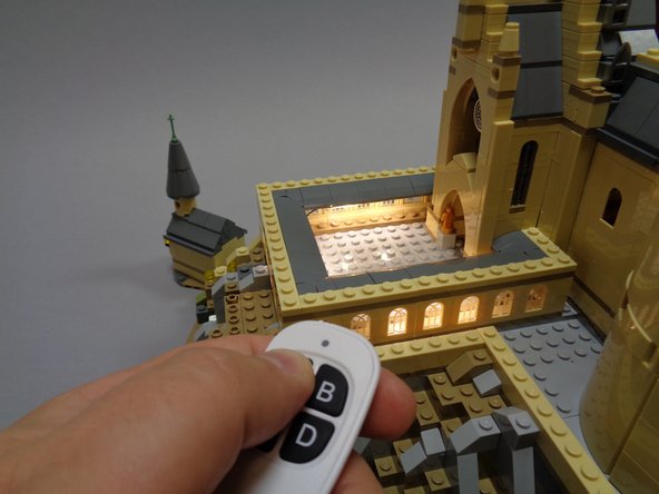 As shown by the green arrow in the second photo, connect the light strip power cable to the plug on the TRUNK08 master controller labeled &quot;OUT2&quot;.