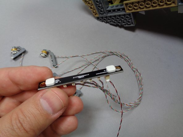 As shown in the third photo, take two sticky squares from Bag 11 and attach them to the backside of the BRANCH17 adapter board.