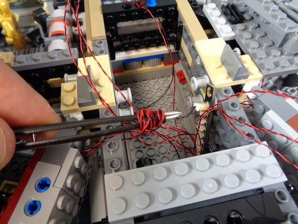 You will have a lot of excess wire inside the right docking bay area.  As shown in the first photo, you can use a tweezers to coil the excess wire so it all fits inside the docking bay space.