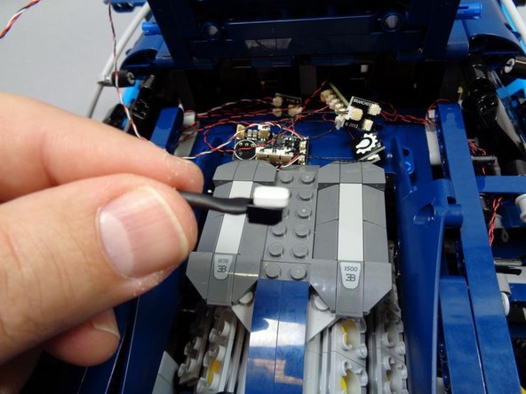 As shown in the first photo, you will have somewhat of a jumble of wires collected in the rear back of your Bugatti.  You can use some of the included sticky squares to mount adapter boards to the flat panel in front of the engine or elsewhere in the area under the roof where the wires will be hidden once the roof is closed again.