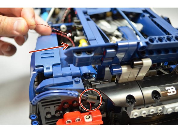 As shown in the first photo, use on the sticky squares included with your kit to mount one of the red Pico LEDs from Bag 1 to the LOWER turn signal cover as shown.