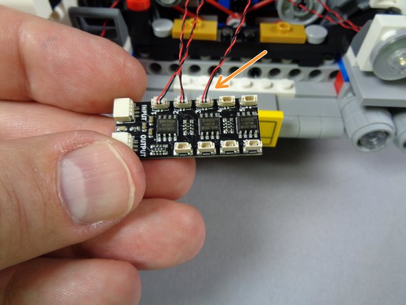 As shown by the orange arrow in the second photo for this step, connect the wire to plug #3 on the BRANCH09X adapter board.