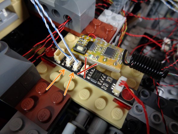 As shown in the first photo, rest the top laser turret on top of your Falcon.  You should have two wires (white/blue) with Pico LED connectors coming from the underside of the top turret.