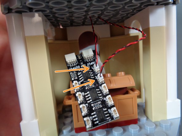 Take the two LED light wires and connect them to plugs #1 and #2 on the BRANCH09X adapter board as shown  by the orange arrows in the second photo.