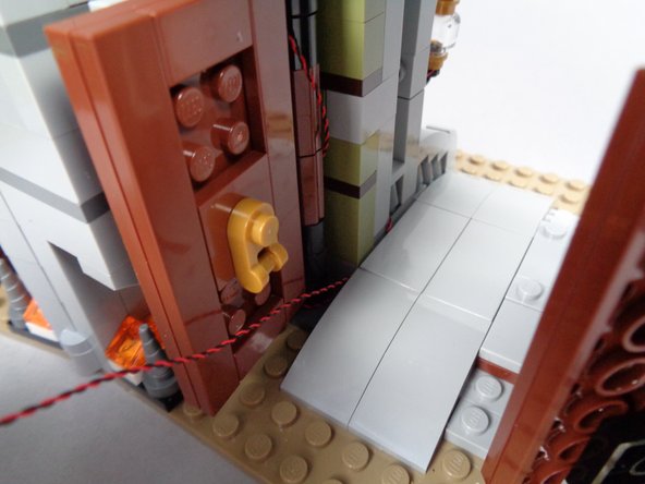 As shown in the third photo for this step, the light wire should pass into the entryway along the wall.